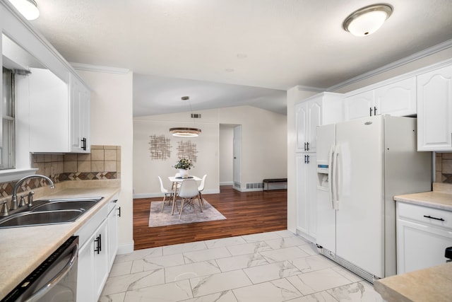 kitchen with backsplash, dishwasher, sink, white refrigerator with ice dispenser, and white cabinets