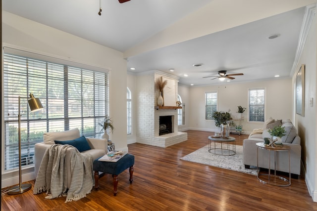 living room with ceiling fan, a healthy amount of sunlight, a fireplace, and hardwood / wood-style flooring