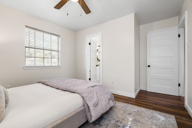 bedroom with ceiling fan, ensuite bathroom, and dark hardwood / wood-style flooring