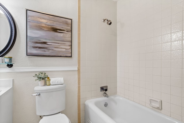 full bathroom with toilet, tiled shower / bath combo, and vanity