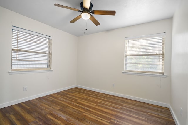 empty room featuring ceiling fan and dark hardwood / wood-style flooring