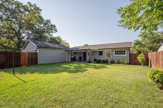 rear view of house with a yard