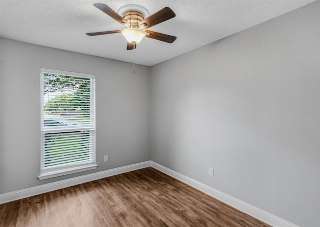 unfurnished room with ceiling fan, wood-type flooring, and a textured ceiling