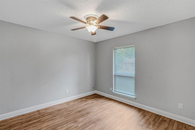 empty room featuring ceiling fan, a textured ceiling, and light hardwood / wood-style flooring