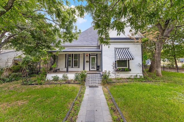 view of front of home with a front yard and covered porch