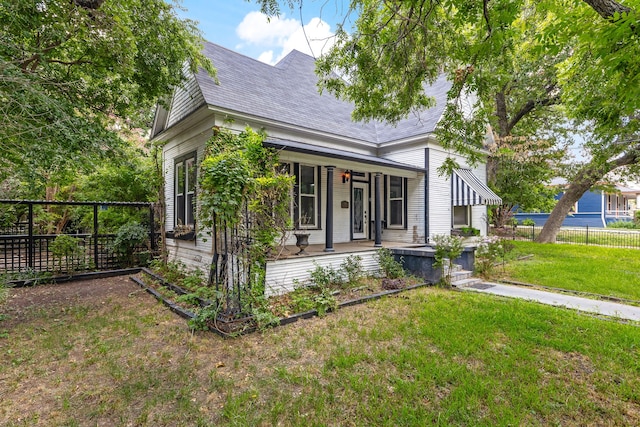 view of side of home with a lawn and a porch