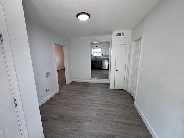 hallway with dark wood-type flooring