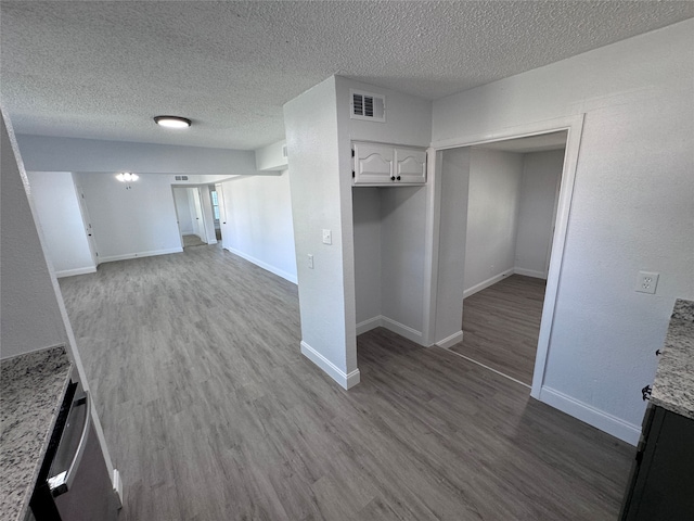 interior space with wood-type flooring and a textured ceiling