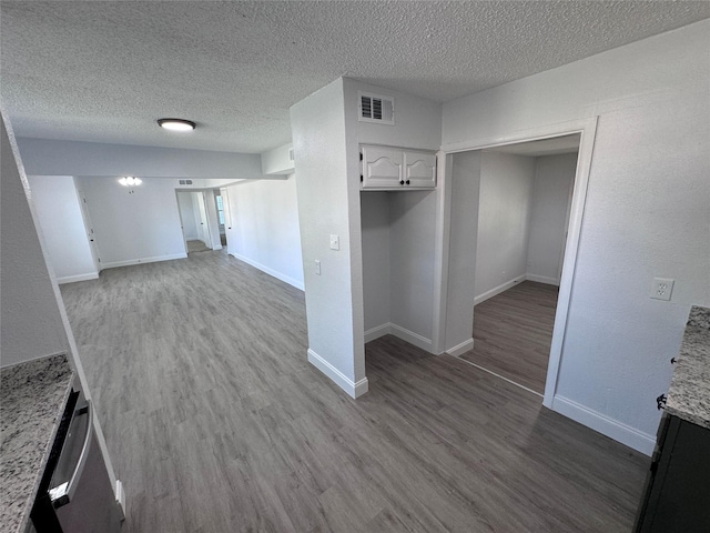 interior space with hardwood / wood-style flooring and a textured ceiling