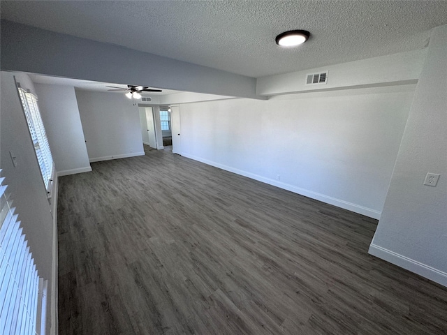 unfurnished room with dark hardwood / wood-style flooring, plenty of natural light, and a textured ceiling