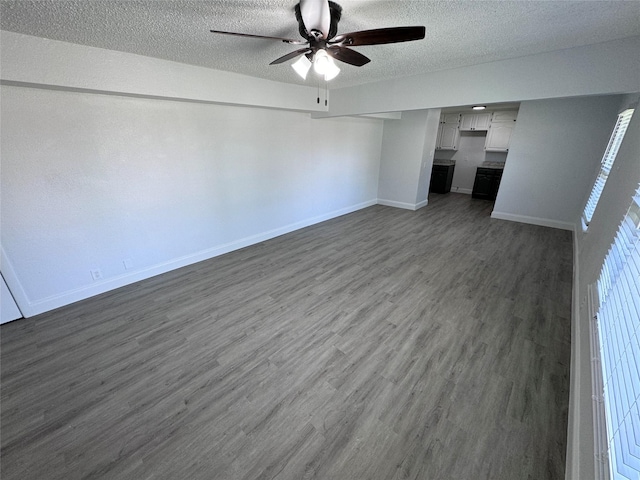 interior space featuring ceiling fan, dark hardwood / wood-style flooring, and a textured ceiling