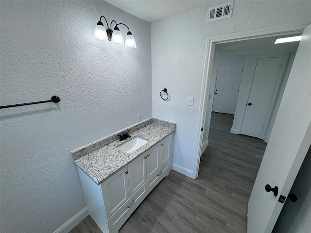 bathroom with vanity and hardwood / wood-style floors