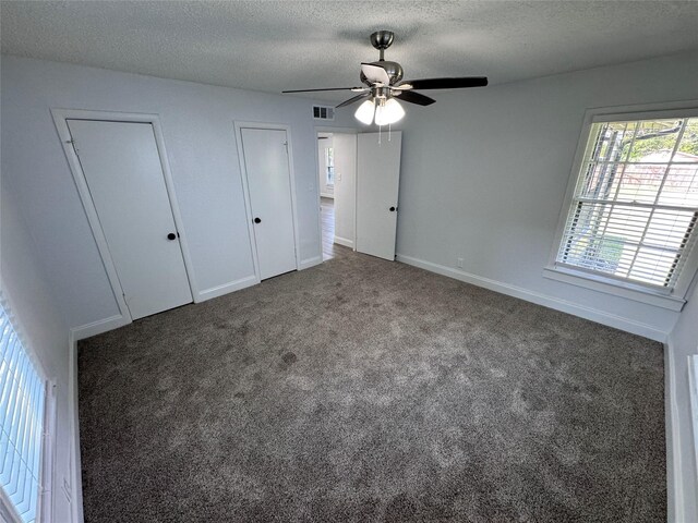 unfurnished bedroom featuring a textured ceiling, ceiling fan, and carpet flooring