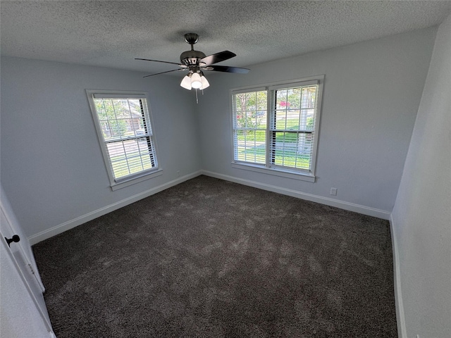 unfurnished room featuring dark colored carpet, a textured ceiling, and ceiling fan