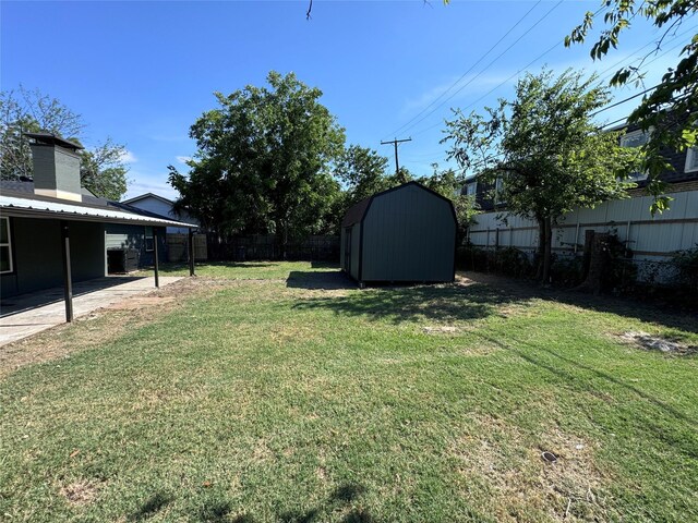 view of yard featuring a storage shed and a patio area