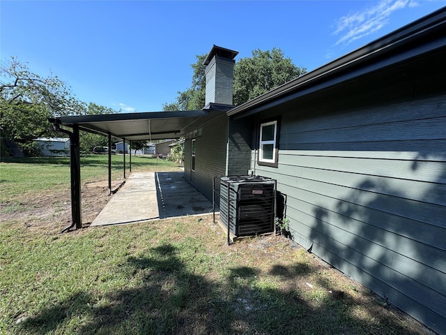 view of yard featuring central AC unit and a patio area