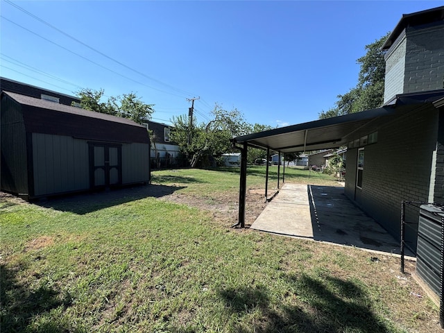 view of yard with a shed and a patio area