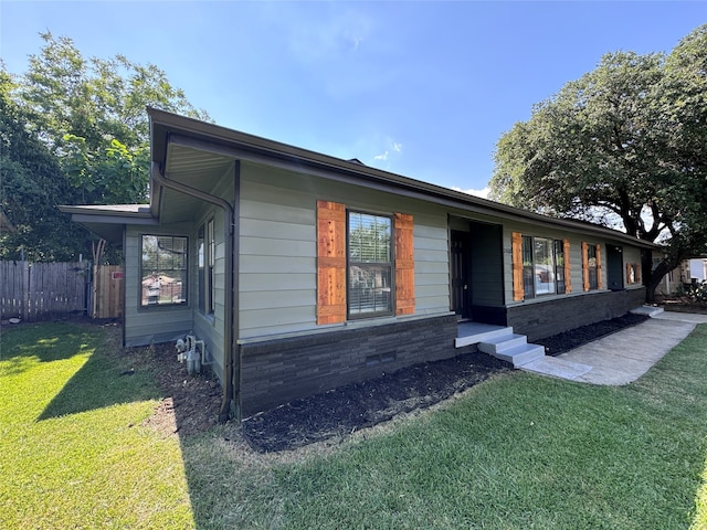 view of property exterior with a lawn