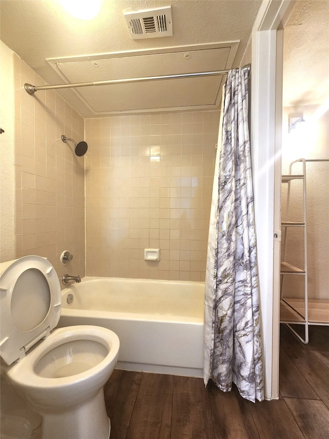 bathroom featuring toilet, shower / bath combo, and hardwood / wood-style floors