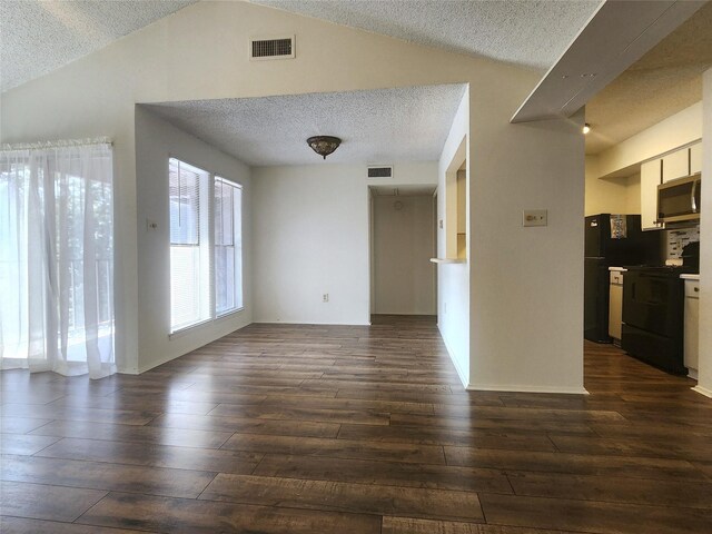 unfurnished living room with a textured ceiling, hardwood / wood-style flooring, and vaulted ceiling