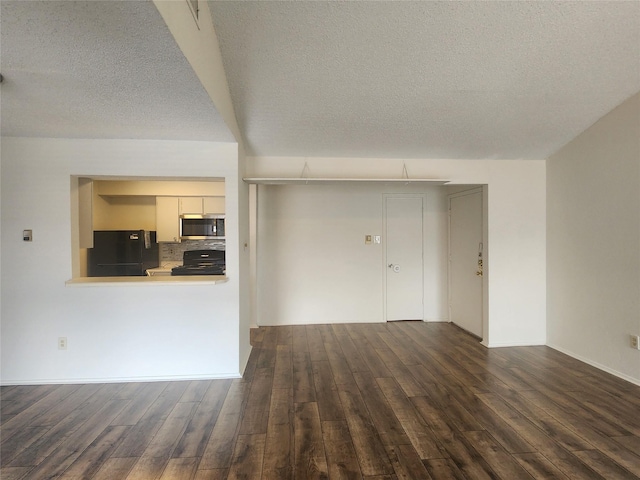 unfurnished living room featuring dark hardwood / wood-style flooring and a textured ceiling