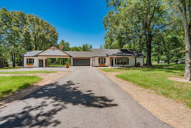 ranch-style house with a garage and a front lawn