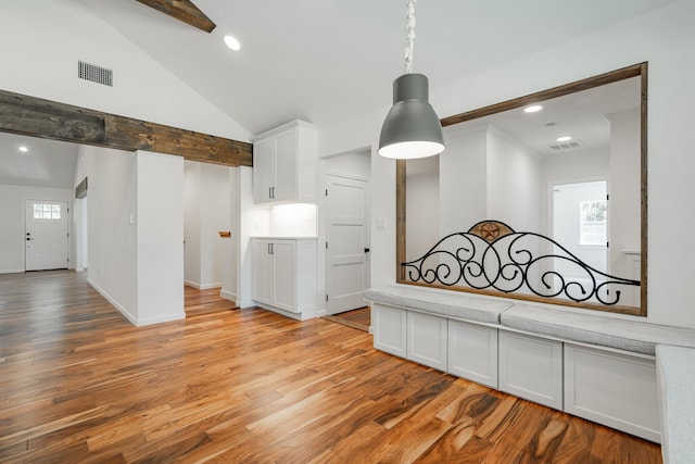 interior space featuring beamed ceiling, high vaulted ceiling, and light wood-type flooring