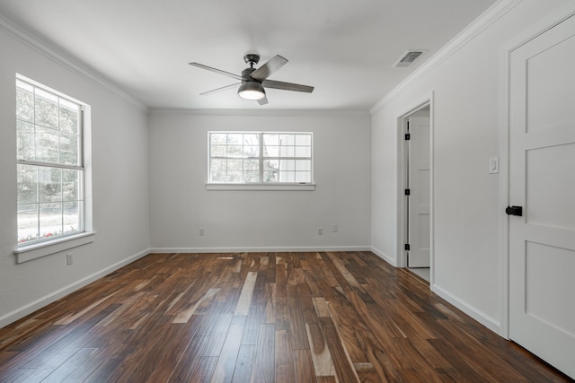 empty room featuring ceiling fan, dark wood-type flooring, and crown molding