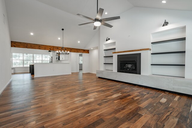 unfurnished living room with high vaulted ceiling, dark wood-type flooring, built in shelves, and ceiling fan