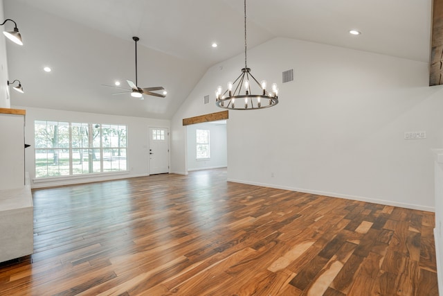 unfurnished living room featuring wood-type flooring, ceiling fan with notable chandelier, and high vaulted ceiling