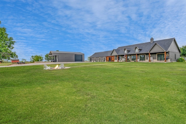 view of yard with a garage and an outdoor structure