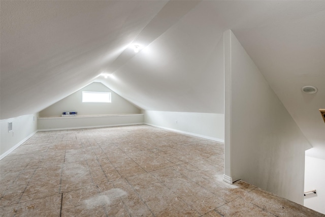 additional living space featuring vaulted ceiling