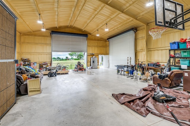 garage with wooden walls and a workshop area