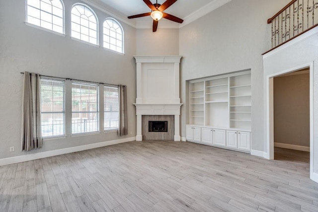 unfurnished living room with light wood-type flooring, ceiling fan, and ornamental molding