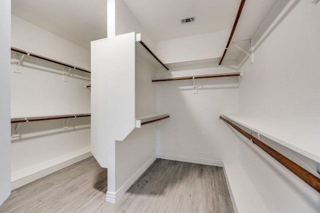 spacious closet featuring light hardwood / wood-style flooring