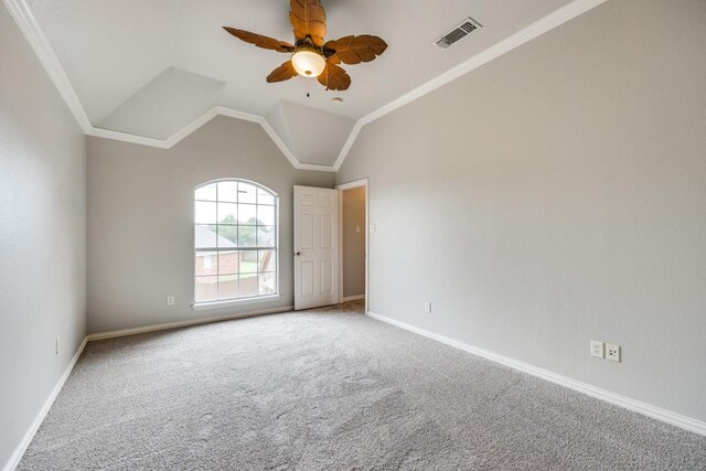 carpeted empty room featuring ceiling fan, lofted ceiling, and ornamental molding