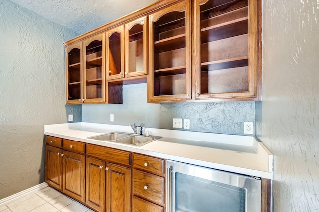 kitchen with sink, light tile patterned floors, and wine cooler