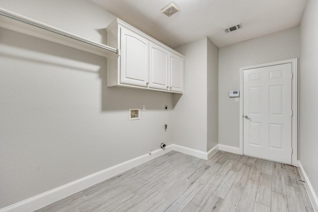 laundry room with washer hookup, light hardwood / wood-style flooring, hookup for a gas dryer, hookup for an electric dryer, and cabinets