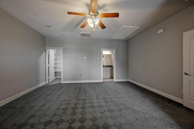 unfurnished room featuring dark colored carpet and ceiling fan