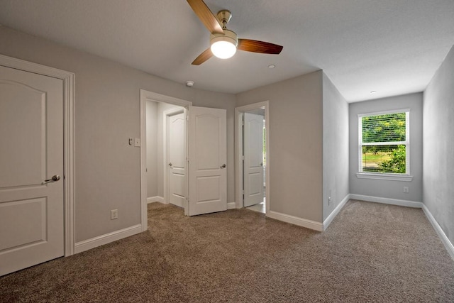 unfurnished bedroom featuring ceiling fan and light colored carpet