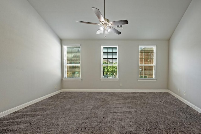 carpeted spare room with ceiling fan and lofted ceiling