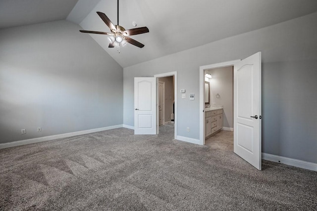 unfurnished bedroom with vaulted ceiling, connected bathroom, light colored carpet, and ceiling fan