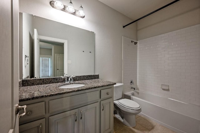 full bathroom featuring tiled shower / bath combo, vanity, tile patterned floors, and toilet