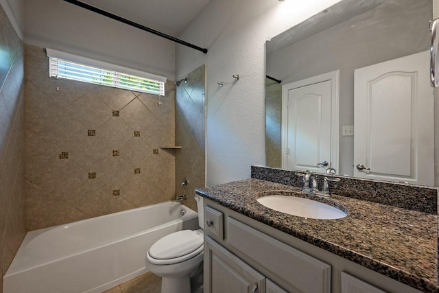 full bathroom with tiled shower / bath, vanity, and toilet