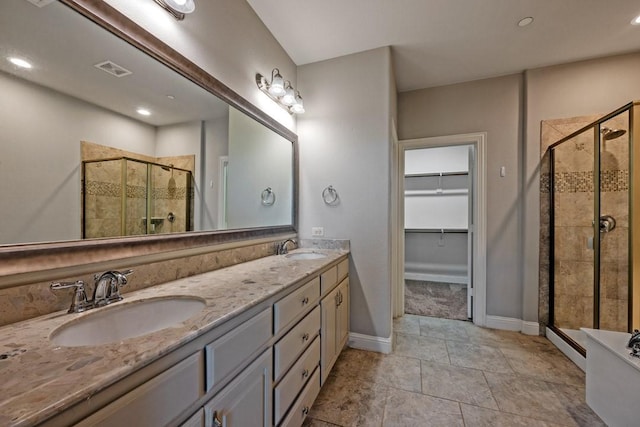 bathroom featuring vanity and a shower with shower door