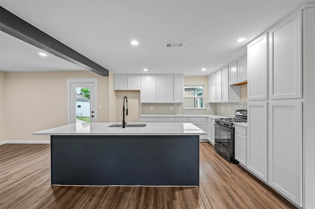 kitchen featuring white cabinetry, black range with gas stovetop, hardwood / wood-style floors, sink, and a kitchen island