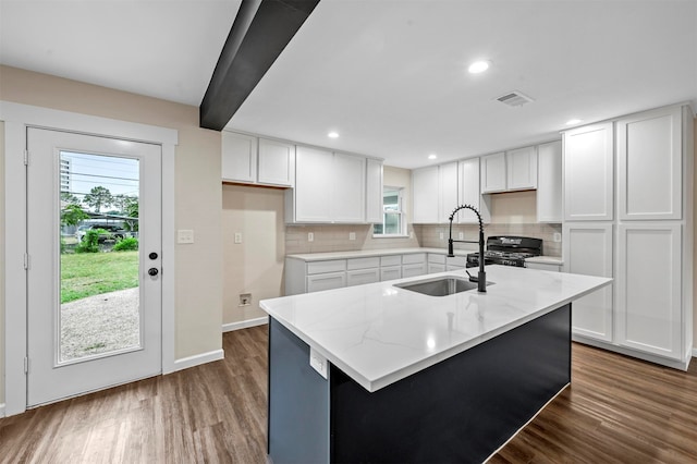 kitchen featuring sink, dark hardwood / wood-style flooring, and white cabinetry