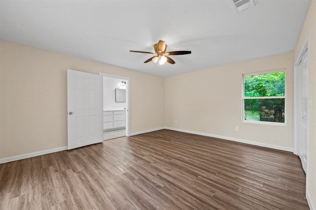 empty room with hardwood / wood-style floors and ceiling fan