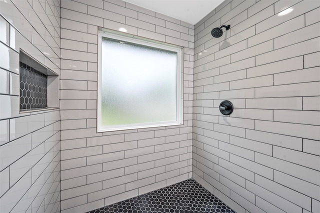 bathroom with a tile shower