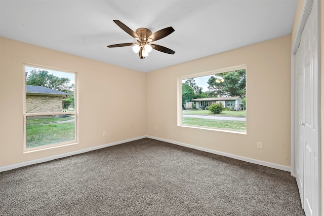 unfurnished bedroom with a closet, multiple windows, carpet floors, and ceiling fan